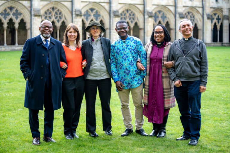 The Racial Justice Action Group standing within the grounds of Norwich Cathedral