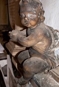 A cherub in need of cleaning inside a church