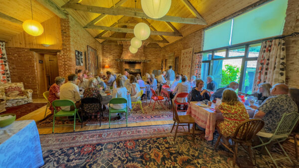 A picture inside a parish hall where people are enjoying a meal of Palestinian food